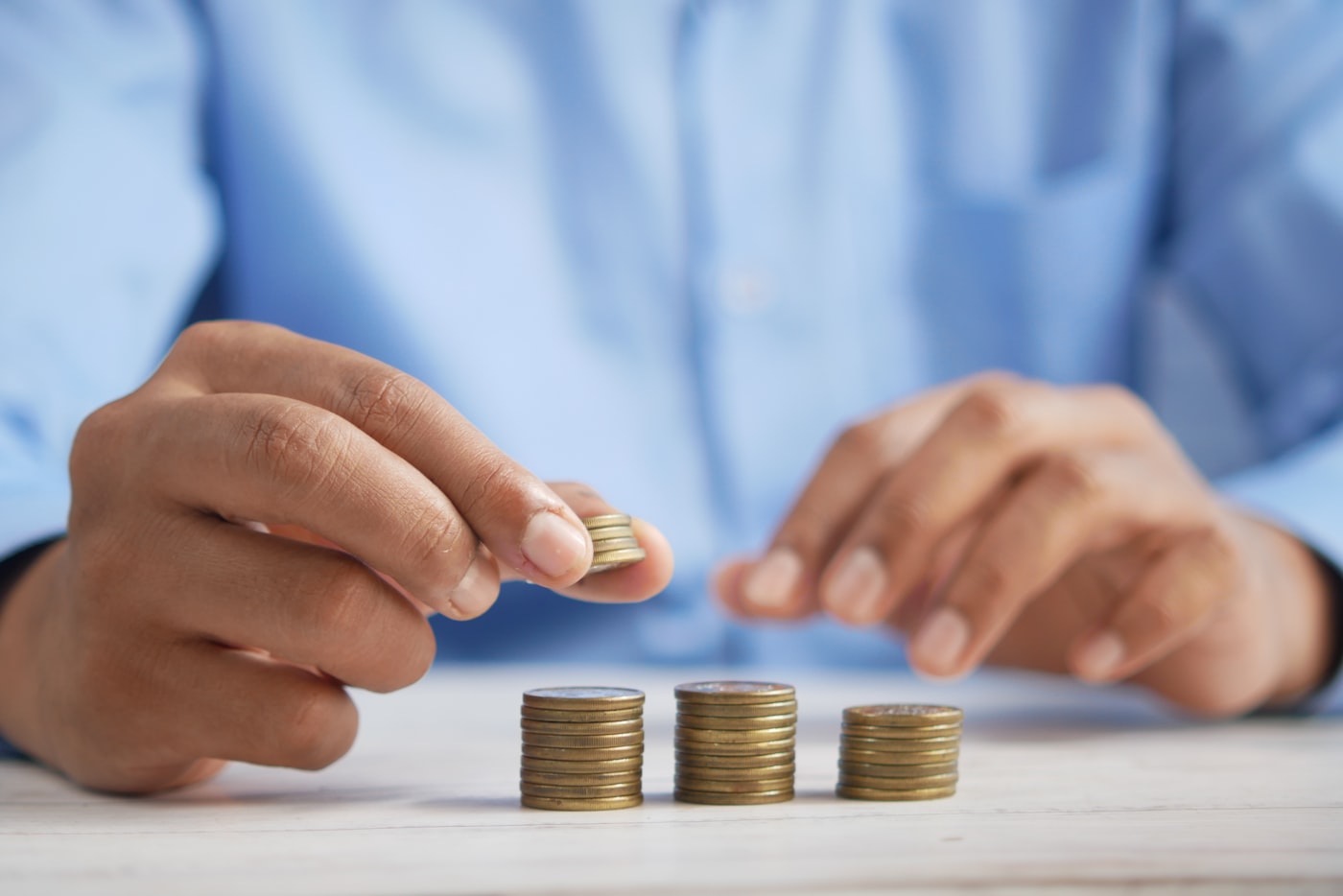 Stacked coins growing in three rising columns